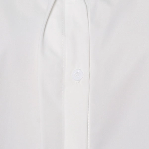 Close-up of white shirt button and clean stitching on fine woven cotton fabric