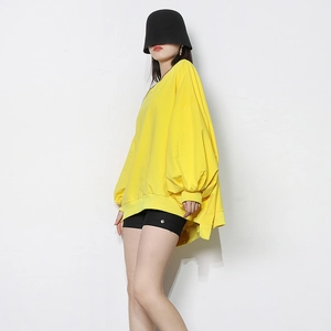Macro side view of bright yellow oversized sweatshirt featuring dropped shoulder seams
