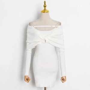Close-up of white knit dress with twist front neckline and clear shoulder straps