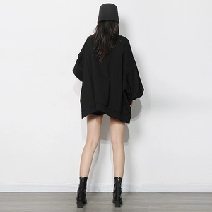 Rear view of a black oversized crewneck sweatshirt with dropped shoulders and ribbed cuffs