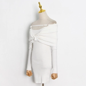 Detail of white rib-knit dress featuring shoulder knot design and textured fabric