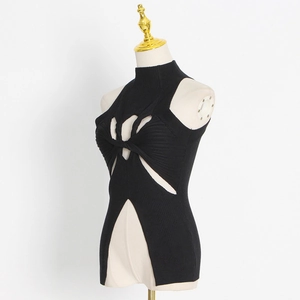 Detail view of black ribbed knit top featuring a twist knot cutout and asymmetric hem
