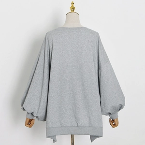 Close-up of grey oversized sweatshirt with drop shoulder balloon sleeves and ribbed cuffs