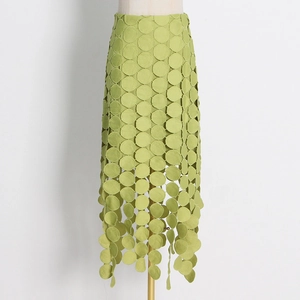 Détail d'une jupe mi-longue vert citron avec broderie laser circulaire et bordure frangée
