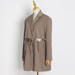 Detail view of coffee brown blazer featuring unique waist cut-outs and tie-up strap design