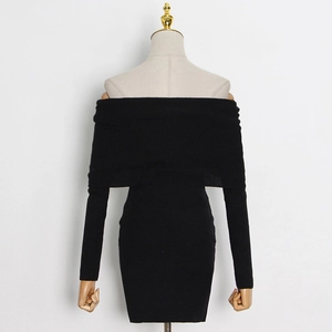 Detailed view of the ribbed knit fabric and off-shoulder neckline on black mini dress