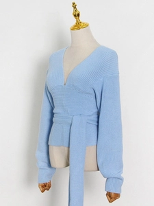 Slim fit light blue V-neck knit top with ribbed texture and waist belt for women