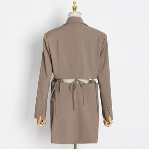 Detail view of brown blazer dress featuring back cutout and elegant ribbon tie closure