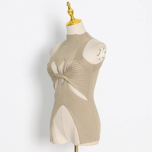 Detail of khaki ribbed knit top featuring a cross-knot cutout and high side slits