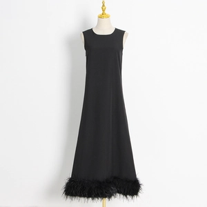 Elegant sleeveless black A-line maxi dress featuring a feather hemline on a white mannequin