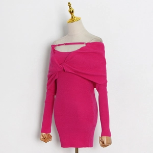 Detail of rose red knit dress showing the twist front design and ribbed texture fabric