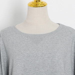 Detailed view of the ribbed crew neck and V-stitch on the grey marl cotton sweatshirt