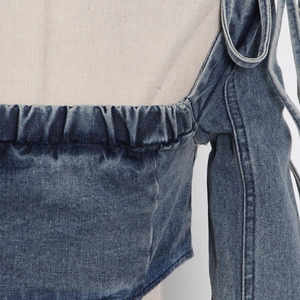 Close-up of vintage blue denim off-shoulder top with elastic neckline and tie cuffs