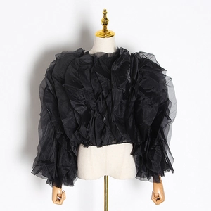 Detail of tiered black organza ruffles on a chic French style short blouse top