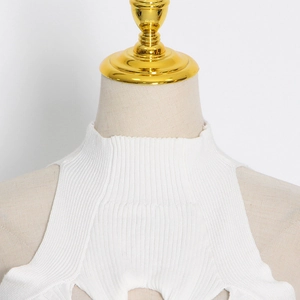Detail of white knit halter top featuring ribbed texture and ruffled high-neck collar