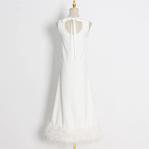 Detail of elegant white sleeveless dress featuring a back cutout and feathered hemline