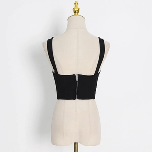 Detail view of black ribbed knit vest back with functional silver zipper closure