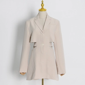 Detail view of beige cut-out waist blazer jacket with notched lapel and long sleeves