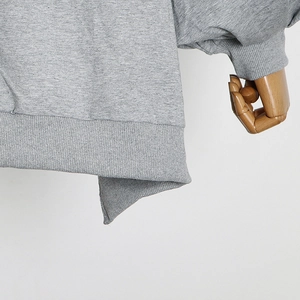 Detailed macro view of the ribbed cuffs and hem on this light grey cotton blend sweatshirt