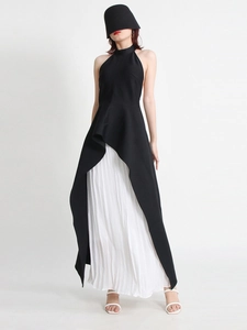 Chic black halter neck asymmetrical top paired with white pleated maxi skirt two-piece set