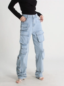 Detail view of light blue cargo jeans showing large flap pockets and denim texture