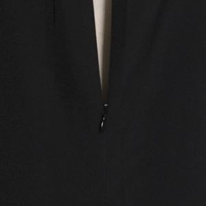 Detail shot of the hidden zipper closure on the black sleeveless feather evening dress