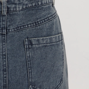 Close-up of dark grey washed denim waist with detailed double-needle stitching and texture
