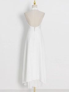 Detailed back view of a white halter dress featuring open back design and pleats