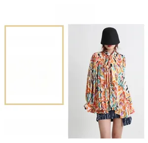Detail of loose fit blouse with retro ethnic print and decorative neck ties