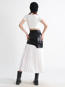 Rear view of a street style midi pleated skirt with black PU waist and white mesh panels
