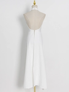 Detailed view of the elegant backless design and invisible zipper on the white halter gown