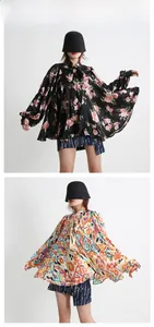 Detail of ruffle tie neckline and lantern sleeves on a vintage printed chiffon blouse