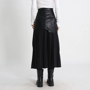 Detail of high waist black PU leather pleated skirt with mesh panel and back zipper