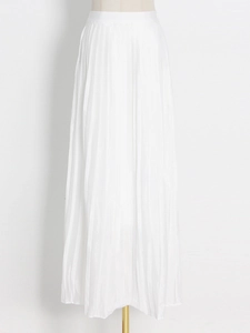 Detail of elegant white pleated maxi skirt in high-waisted design for special events