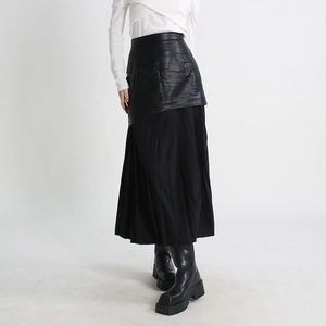 Detail of high waist black faux leather midi skirt with pleated mesh patchwork design