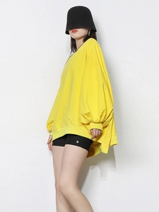 Minimalist bright yellow crewneck sweatshirt with dropped shoulders and relaxed fit style