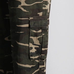 Close-up detail of camouflage street style cargo pants featuring large side flap pockets