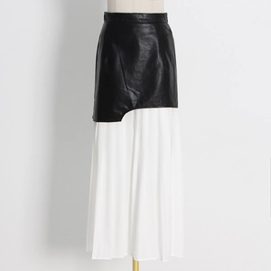 Detailed view of asymmetric black faux leather and white pleated gauze patchwork skirt