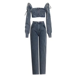 Two-piece wash blue denim set featuring off-shoulder zip crop top and high-waisted wide-leg pants