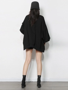 Minimalist black oversized pullover sweatshirt with casual streetwear style and boots
