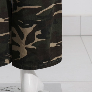 Detailed view of camouflage print wide leg pants with flat seam stitching at the hem
