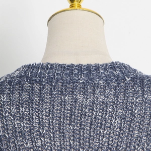 Close-up of crew neck detailing on blue and white textured knit sweater with ribbed trim