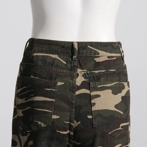 Detail view of camouflage jeans back pockets and waistline on a fashion mannequin