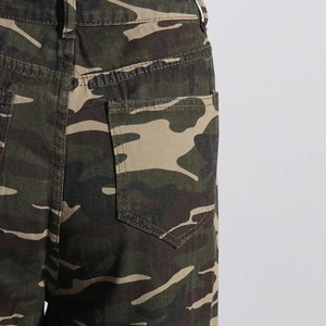 Detailed view of camouflage wide-leg jeans with back pocket and reinforced stitching