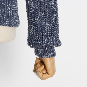 Detail of blue and white chunky knit sweater cuff with ribbed hem on mannequin arm