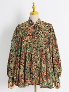 Detail of high neck tie bow and tropical leaf print on this vintage loose long sleeve shirt