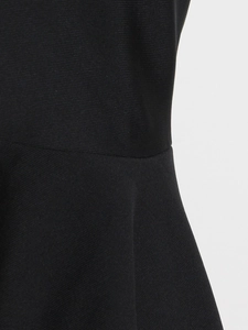 Detailed macro view of the black twill fabric texture and waist seam of the elegant dress