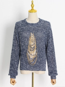 Blue and white knit sweater featuring distressed hollow details and gold chain fringe