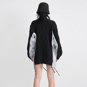 Detailed back view of a cable knit denim patchwork sweater with drawstring hem