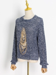 Blue and white chunky knit sweater with round neck and decorative gold metal chains
